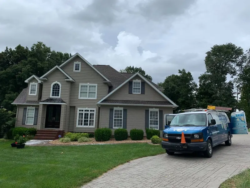 Gray two-story home with the Shine Brite van
