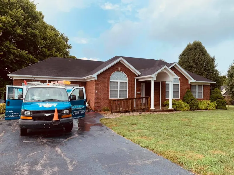 Brick home driveway just cleaned, with the Shine Brite van